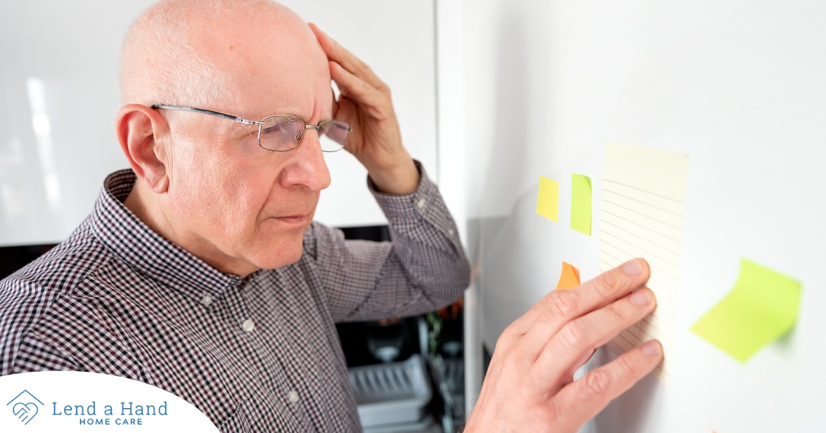 A senior looks at a board confused, representing one of the potential signs of dementia.